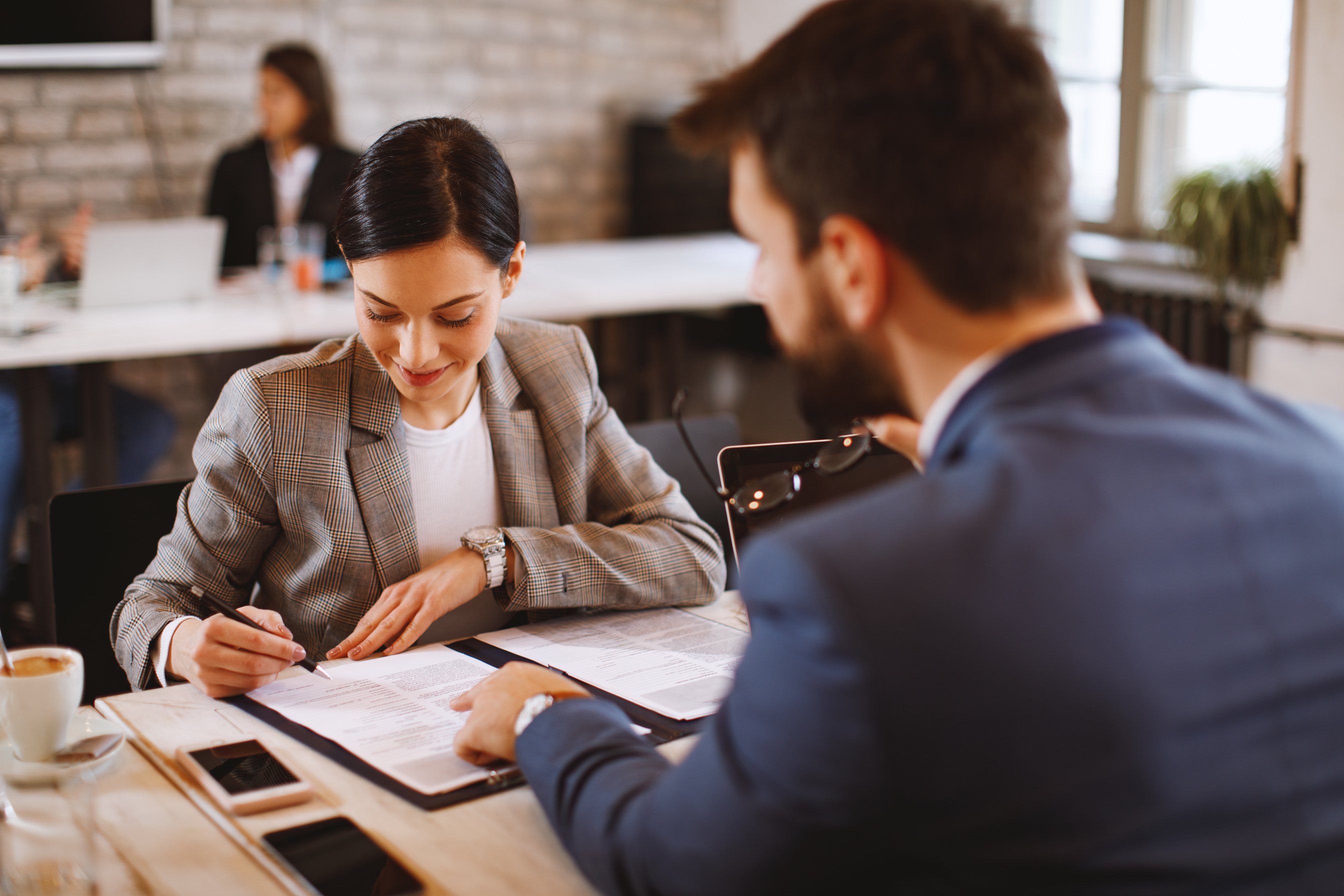 Young woman signs an employment contract